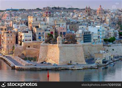 Aerial view from the fortress wall on the historical part of the old city. Malta. Valletta.. Malta. Aerial view of the old town and the bay on a sunny morning.