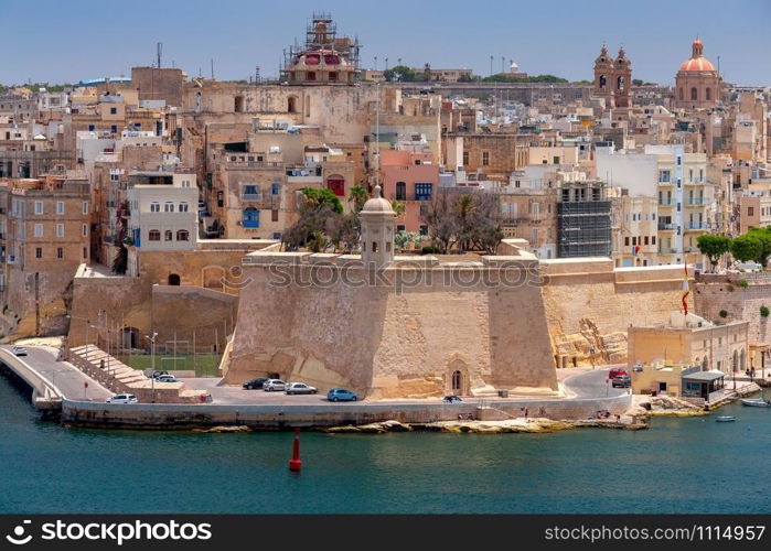 Aerial view from the fortress wall on the historical part of the old city. Malta. Valletta.. Malta. Aerial view of the old town and the bay on a sunny morning.