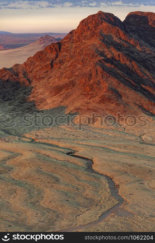Aerial view in the early morning sunlight of the dramatic desert landscape of the Namib-nuakluft National Park near Sossusvlie in Namibia, Africa.
