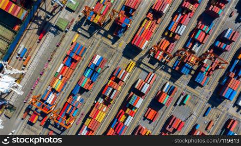 Aerial view industrial containers box from cargo freight ship for import and export in shipping yard with cargo container stack.