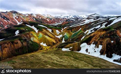 Aerial view landscape of Landmannalaugar surreal nature scenery in highland of Iceland, Europe. Beautiful colorful snow mountain terrain famous for summer trekking adventure and outdoor walking.