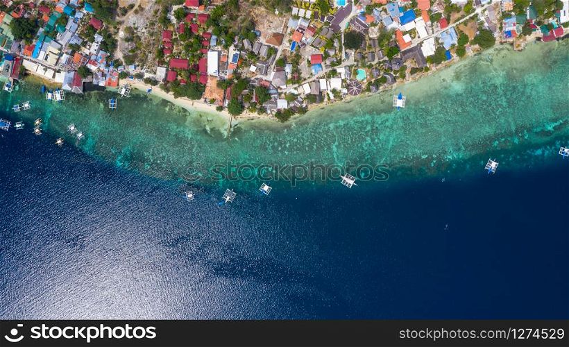 Aerial view local living of philippines at Moalboal a small town on the South-West of Cebu island, Moalboal is a deep clean blue ocean and has many local Filipino boats in the sea. Moalboal, Cebu, Philippines.