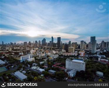aerial view modern building business in city and big blue cloudy sky with transportation both road and river at sunset background