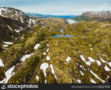 Aerial view. Norway landscape. Road and lakes in stony rocks mountains. Norwegian national tourist scenic route Ryfylke.. Aerial view. Road and lakes in mountains Norway