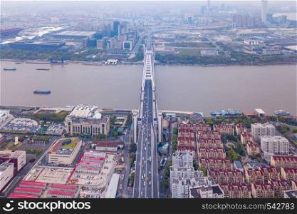 Aerial view of a bridge with Huangpu River Shanghai Downtown skyline, China. Buildings in residential area.