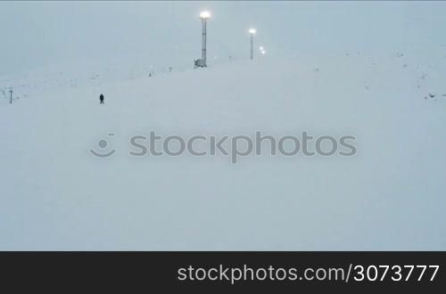Aerial view of a lonely skier down the slope at a ski resort in bad weather