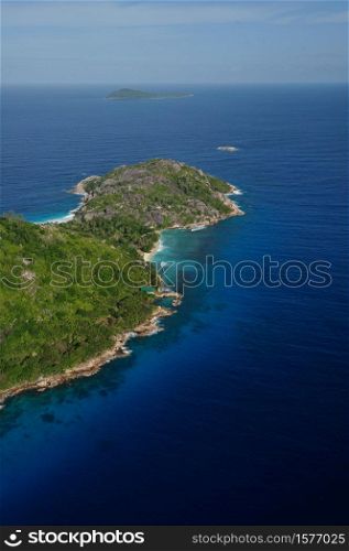 Aerial view of a tropical island with coastline and blue ocean. Felicite Island, La Digue, Seychelles