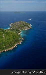 Aerial view of a tropical island with coastline and blue ocean. Felicite Island, La Digue, Seychelles