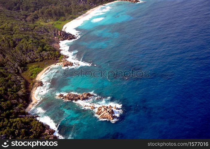Aerial view of a tropical island with coastline and blue ocean. La Digue Island, Seychelles