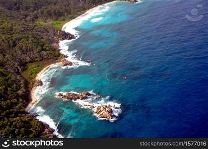 Aerial view of a tropical island with coastline and blue ocean. La Digue Island, Seychelles