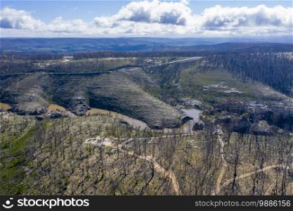 Aerial view of a water reservoir surrounded by forest regeneration after bushfires in Dargan in the Central Tablelands in regional New South Wales Australia