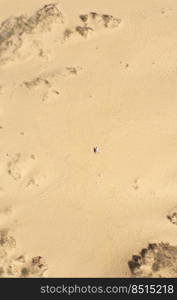 Aerial view of a young couple lying on the white sand. man and woman spend time together and travel through the desert.. Aerial view of a young couple lying on the white sand. man and woman spend time together and travel through the desert