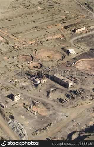 Aerial view of abandoned industrial facility in state of disrepair.