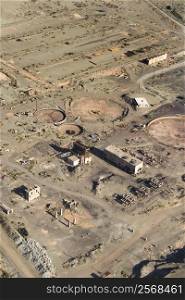 Aerial view of abandoned industrial facility in state of disrepair.