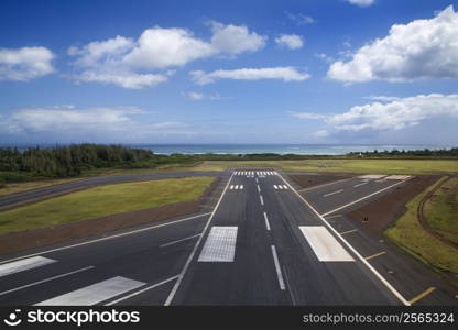 Aerial view of airport runway on coastline of Maui, Hawaii.