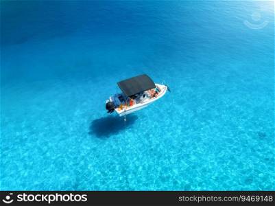Aerial view of alone small motorboat on the sea in summer sunny day. Oludeniz, Turkey. Top drone view of bay, yacht, sailboats, transparent blue water, sand, Travel. View from above of beautiful boat