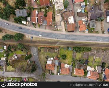 Aerial view of an old housing estate on the outskirts of the city with railway tracks close to the buildings, drones shot