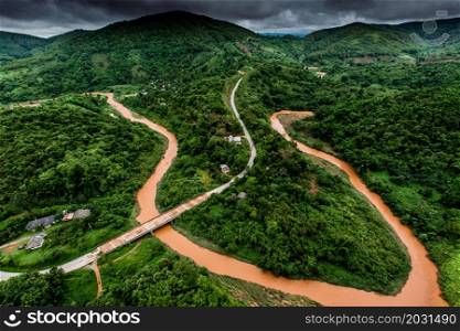 Aerial view of an overflowing creek with landslide on rainy season. Rural scene near Thailand-Myanmar border. Environment, climate change, weather concepts.