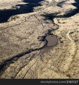 Aerial view of Arizona desert landscape with small water source.
