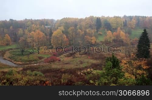 Aerial view of autumn forest and curving river in Toila, Estonia.