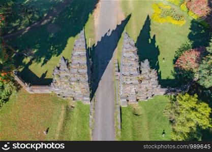 Aerial view of Bali Handara. The Hindu Temple with ancient gate with pathway in park garden at noon. Hindu architecture landscape background of travel trip and holidays vacation in Indonesia.
