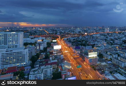 Aerial view of Bangkok Downtown skyline, highway roads or street in Thailand. Financial district and business area in smart urban city. Skyscraper and high-rise buildings at night.