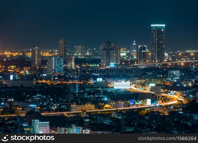 Aerial view of Bangkok Downtown skyline, highway roads or street in Thailand. Financial district in smart urban city. Skyscraper and high-rise buildings at night.