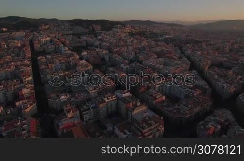 Aerial view of Barcelona at sunset. Cityscape with streets and houses, Spain