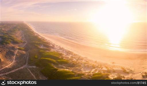 Aerial view of beach and sand dunes at sunset in Murtosa, Aveiro - Portugal. South view.