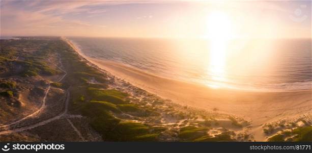 Aerial view of beach and sand dunes at sunset in Murtosa, Aveiro - Portugal. South view.