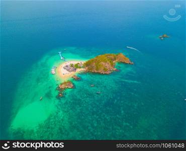 Aerial view of beach at Koh Khai, a small island, with crowd of people, tourists, blue turquoise seawater with Andaman sea in Phuket island in summer, Thailand in travel trip. Nature landscape.