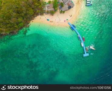Aerial view of beach at Koh Khai, a small island, with crowd of people, tourists, blue turquoise seawater with Andaman sea in Phuket island in summer, Thailand in travel trip. Nature landscape.