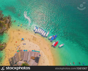 Aerial view of beach at Koh Khai, a small island, with crowd of people, tourists, blue turquoise seawater with Andaman sea in Phuket island in summer, Thailand in travel trip. Nature landscape.