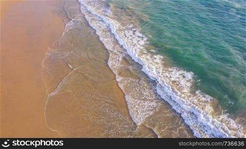 Aerial view of beach with waves rolling into the shore with copy space for travel, holidays vacation outdoor background, Andaman sea, Phuket bay island in summer season, Thailand. Top view