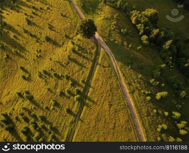Aerial view of beautiful mountain Carpathians, Ukraine in sunlight. Drone filmed an landscape with coniferous and beech forests, around a winding serpentine road, copter aerial photo.. Aerial view of beautiful mountain Carpathians, Ukraine in sunlight. Drone filmed an landscape with coniferous and beech forests, around a winding serpentine road, copter aerial photo