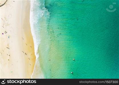 Aerial view of beautiful sandy beach with tourists swimming in beautiful andaman sea in phuket thailand,Amazing nature background and summer background.