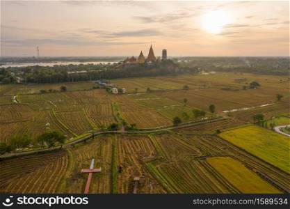 Aerial view of Big Golden Buddha Statue and pagoda in Tiger Cave Temple or Wat Tham Suea in Kanchanaburi province, Thailand. Famous tourist attraction landmark in travel trip concept.
