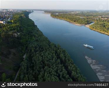 Aerial view of big siberian Ob river and ship, summer day, drone shot. Aerial view of big siberian Ob river