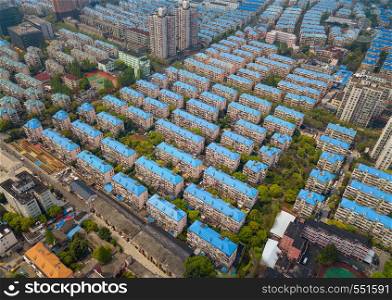 Aerial view of blue houses. Residential neighborhood. Urban housing development from above. Top view. Real estate in Shanghai City, China