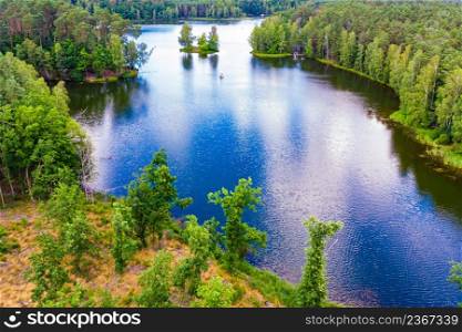 Aerial view of boat yacht on lake during summer. Tuchola national park in Poland. Yachting, holidays concept.. Aerial view yacht on lake in Tuchola Forests, Poland.