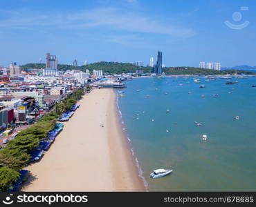 Aerial view of boats in Pattaya sea, beach in summer, and urban city with blue sky for travel background. Chon buri Province, Thailand.