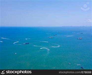 Aerial view of boats in Pattaya sea, beach with blue sky for travel background. Chonburi, Thailand.