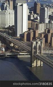 Aerial view of Brooklyn Bridge with Chinatown and New York City buildings.
