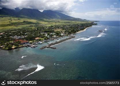 Aerial view of buildings and marina on coastline of Maui, Hawaii.