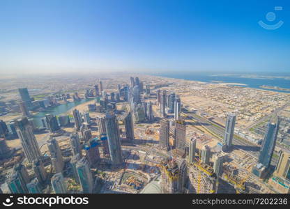 Aerial view of Burj Khalifa in Dubai Downtown skyline and fountain, United Arab Emirates or UAE. Financial district and business area in smart urban city. Skyscraper and high-rise buildings at sunset.