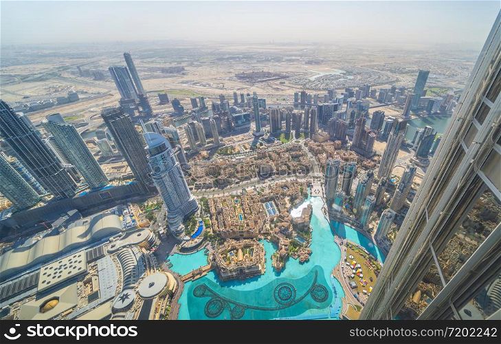Aerial view of Burj Khalifa in Dubai Downtown skyline and fountain, United Arab Emirates or UAE. Financial district and business area in smart urban city. Skyscraper and high-rise buildings at sunset.