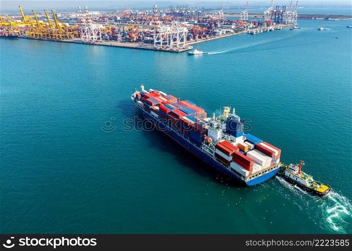 Aerial view of cargo ship and cargo container in harbor.