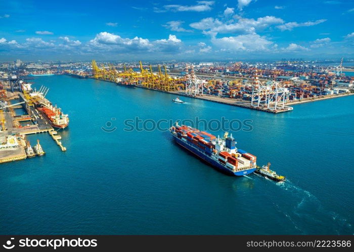 Aerial view of cargo ship and cargo container in harbor.