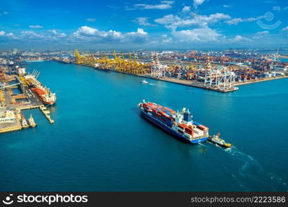 Aerial view of cargo ship and cargo container in harbor.