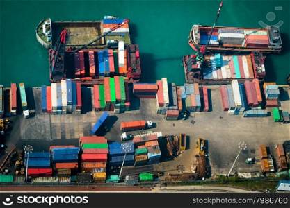 Aerial view of cargo ships loaded by crane with cargo containers at a busy port terminal. Hong Kong